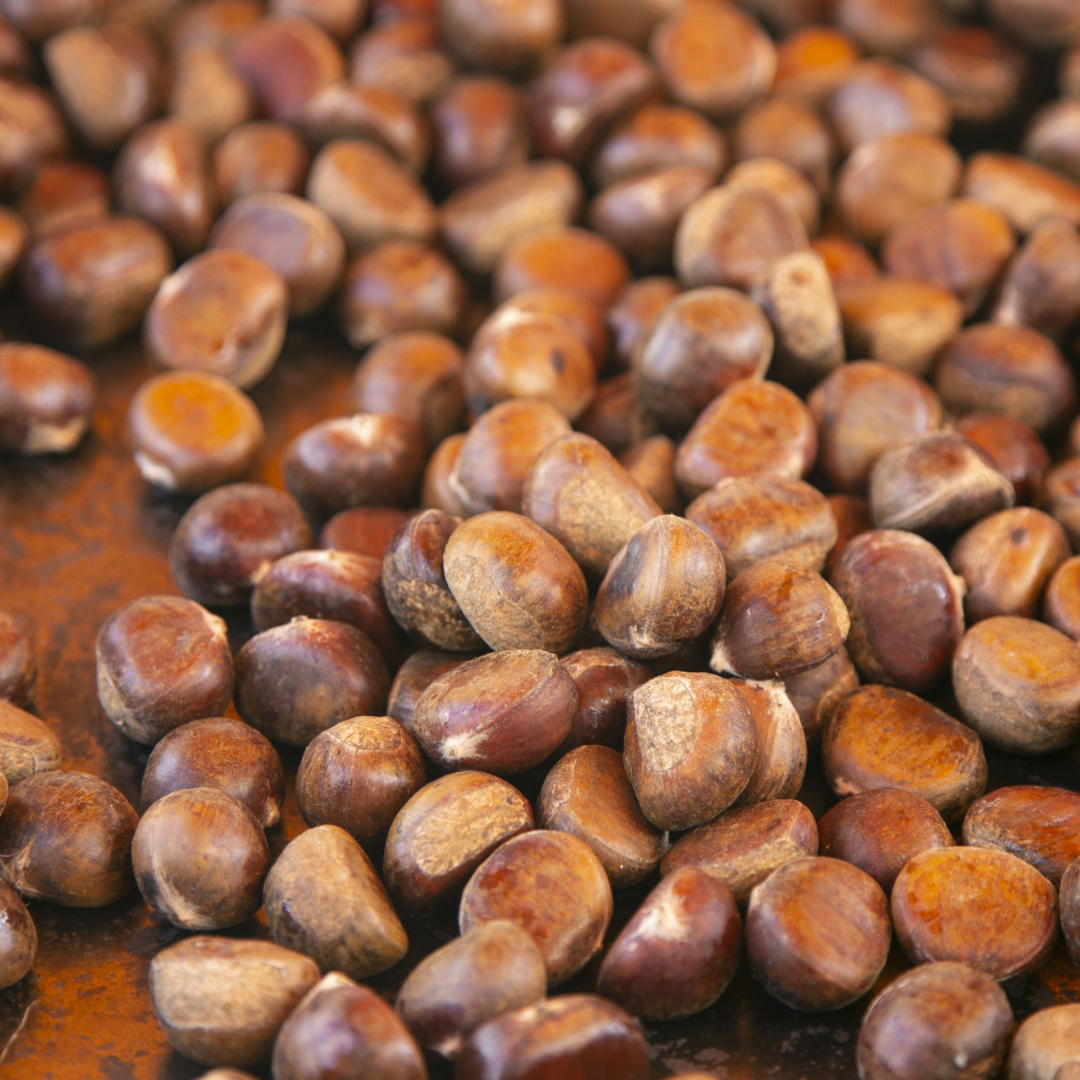 Close-up of a pile of japanese chestnut seeds on a wooden surface